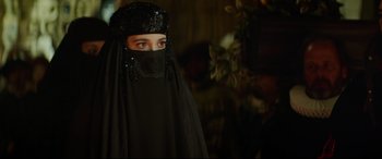 Movie still from “The Man Who Killed Don Quixote” (2018), directed by Terry Gilliam – A woman wearing a black veil and a black hat; Close Up shot, Over the shoulder angle