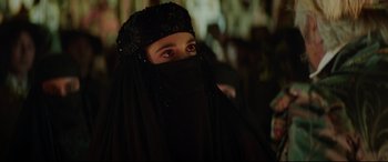 Movie still from “The Man Who Killed Don Quixote” (2018), directed by Terry Gilliam – A woman wearing a black veil and a black headscarf; Close Up shot, Over the shoulder angle