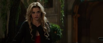 Movie still from “The Man Who Killed Don Quixote” (2018), directed by Terry Gilliam – A woman with long blonde hair standing in the rain; Close Up shot, Over the shoulder angle