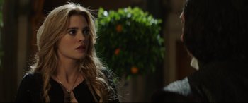 Movie still from “The Man Who Killed Don Quixote” (2018), directed by Terry Gilliam – A beautiful woman with long blonde hair standing in front of a tree; Close Up shot, Over the shoulder angle