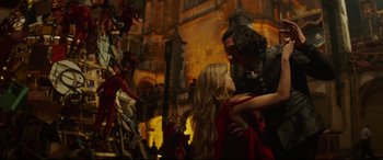 Movie still from “The Man Who Killed Don Quixote” (2018), directed by Terry Gilliam – A man and a woman are standing in front of statues; Medium shot, Low angle