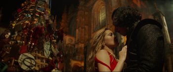 Movie still from “The Man Who Killed Don Quixote” (2018), directed by Terry Gilliam – A man and a woman kissing in front of a building; Medium shot, Low angle