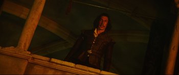 Movie still from “The Man Who Killed Don Quixote” (2018), directed by Terry Gilliam – A man standing on top of a building in the dark; Medium shot, Low angle