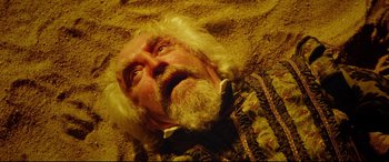 Movie still from “The Man Who Killed Don Quixote” (2018), directed by Terry Gilliam – An old man with white beard laying on the ground; Close Up shot, Overhead angle