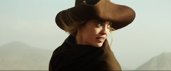 Movie still from “The Man Who Killed Don Quixote” (2018), directed by Terry Gilliam – A woman wearing a brown hat and a brown scarf; Close Up shot, Low angle