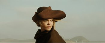 Movie still from “The Man Who Killed Don Quixote” (2018), directed by Terry Gilliam – A woman wearing a brown hat and a brown cape; Close Up shot, Low angle