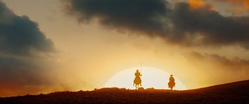 Movie still from “The Man Who Killed Don Quixote” (2018), directed by Terry Gilliam – Two people on horseback in the desert at sunset; Extreme Wide shot, Low angle