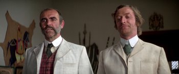 Movie still from “The Man Who Would Be King” (1975), directed by John Huston – A couple of men standing next to each other; Close Up shot, Low angle