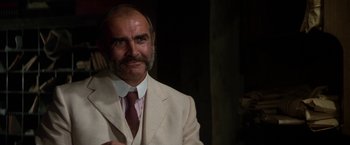 Movie still from “The Man Who Would Be King” (1975), directed by John Huston – An older man in a suit and a tie; Close Up shot, Low angle