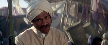 Movie still from “The Man Who Would Be King” (1975), directed by John Huston – A man with a turban is looking at the camera; Close Up shot, Low angle