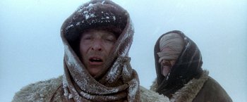 Movie still from “The Man Who Would Be King” (1975), directed by John Huston – A man in a fur hat and a man in a fur coat; Close Up shot, High angle