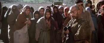 Movie still from “The Man Who Would Be King” (1975), directed by John Huston – A group of people standing in a line; Medium shot, Low angle