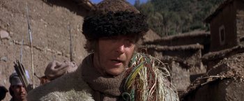 Movie still from “The Man Who Would Be King” (1975), directed by John Huston – A man wearing a fur hat and a scarf; Close Up shot, Low angle