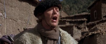 Movie still from “The Man Who Would Be King” (1975), directed by John Huston – A man wearing a fur coat and a fur hat; Close Up shot, Low angle