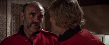 Movie still from “The Man Who Would Be King” (1975), directed by John Huston – A man and a woman talking to each other; Close Up shot, Over the shoulder angle