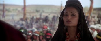 Movie still from “The Man Who Would Be King” (1975), directed by John Huston – A person wearing a headdress; Close Up shot, Over the shoulder angle