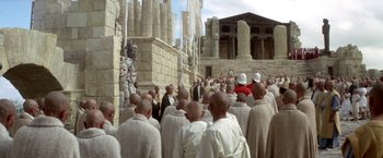 Movie still from “The Man Who Would Be King” (1975), directed by John Huston – A group of men standing next to each other in white robes; Extreme Wide shot, High angle