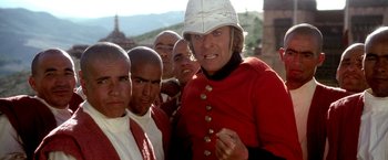 Movie still from “The Man Who Would Be King” (1975), directed by John Huston – A group of people standing next to each other wearing uniforms; Close Up shot, Low angle