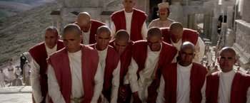 Movie still from “The Man Who Would Be King” (1975), directed by John Huston – A group of men standing next to each other; Medium shot, High angle