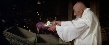 Movie still from “The Man Who Would Be King” (1975), directed by John Huston – An old man is holding something in his hands; Close Up shot, Low angle