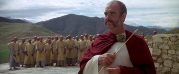 Movie still from “The Man Who Would Be King” (1975), directed by John Huston – Many men standing in a line together; Close Up shot, Low angle