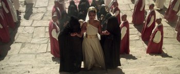 Movie still from “The Man Who Would Be King” (1975), directed by John Huston – A group of people dressed in black and black robes; Wide shot, High angle