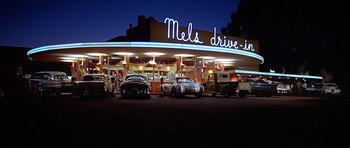 Movie still from “American Graffiti” (1973), directed by George Lucas – Wide shot, Low angle