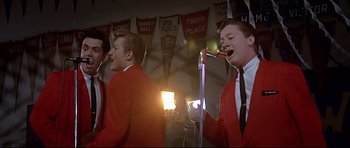 Movie still from “American Graffiti” (1973), directed by George Lucas – Medium shot, Low angle