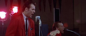 Movie still from “American Graffiti” (1973), directed by George Lucas – Medium shot, Low angle