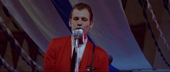 Movie still from “American Graffiti” (1973), directed by George Lucas – Medium shot, Low angle