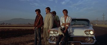 Movie still from “American Graffiti” (1973), directed by George Lucas – Medium shot, Low angle