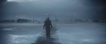 Movie still from “The Mandalorian” (2019), created by Jon Favreau – A man walking on a pier in the middle of the night; Extreme Wide shot, Over the shoulder angle