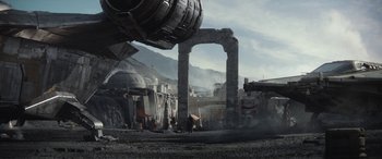 Movie still from “The Mandalorian” (2019), created by Jon Favreau – An old building with a lot of smoke coming out of it; Extreme Wide shot, Low angle