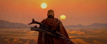 Movie still from “The Mandalorian” (2019), created by Jon Favreau – A man in a red robe holding a rifle in front of a sunset; Wide shot, Low angle