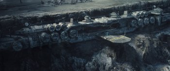 Movie still from “The Mandalorian” (2019), created by Jon Favreau – An aerial view of a space ship in the middle of a field; Extreme Wide shot, High angle