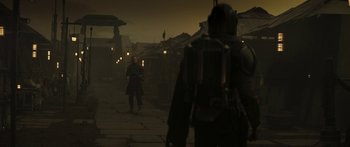 Movie still from “The Mandalorian” (2019), created by Jon Favreau – A man and a woman walking down a street at night; Wide shot, Over the shoulder angle