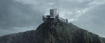 Movie still from “The Mandalorian” (2019), created by Jon Favreau – An image of a building on top of a mountain; Extreme Wide shot, Low angle