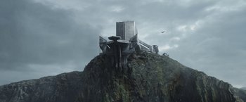Movie still from “The Mandalorian” (2019), created by Jon Favreau – An image of an alien ship on top of a mountain; Extreme Wide shot, Low angle