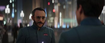 Movie still from “The Mandalorian” (2019), created by Jon Favreau – A man with a beard and glasses is looking into the mirror; Close Up shot, Over the shoulder angle