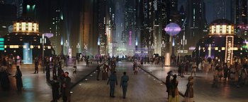 Movie still from “The Mandalorian” (2019), created by Jon Favreau – People are walking in a city at night time; Extreme Wide shot, High angle