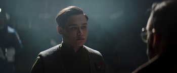 Movie still from “The Mandalorian” (2019), created by Jon Favreau – A young man in a star wars costume; Close Up shot, Low angle