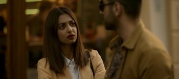 A woman is standing next to a bearded man