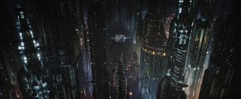 Movie still from “The Mandalorian” (2019), created by Jon Favreau – An aerial view of a futuristic city at night; Extreme Wide shot, High angle