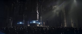 Movie still from “The Mandalorian” (2019), created by Jon Favreau – A large crowd of people are gathered around a stage; Extreme Wide shot, Low angle