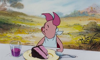 Movie still from “The Many Adventures of Winnie the Pooh” (1977), directed by John Lounsbery – A cartoon pig sitting in front of a piece of cake; Medium shot, High angle