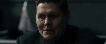 Movie still from “The Marco Effect” (2021), directed by Martin Zandvliet – A person wearing a black shirt; Close Up shot, Over the shoulder angle