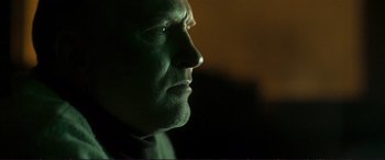 Movie still from “The Marco Effect” (2021), directed by Martin Zandvliet – A man's face in the dark; Close Up shot, Low angle