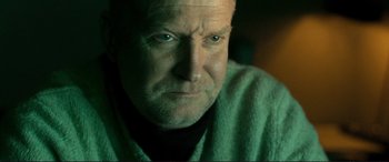 Movie still from “The Marco Effect” (2021), directed by Martin Zandvliet – A person wearing a green sweater; Close Up shot, Low angle