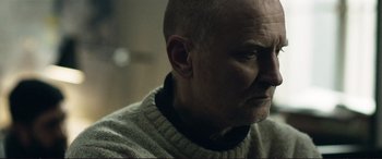 Movie still from “The Marco Effect” (2021), directed by Martin Zandvliet – A person wearing a sweater; Close Up shot, Over the shoulder angle