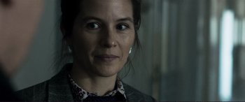 Movie still from “The Marco Effect” (2021), directed by Martin Zandvliet – A woman's face in a dark room; Close Up shot, Over the shoulder angle